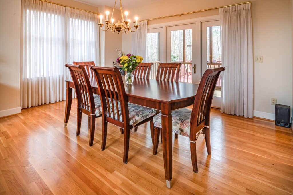 Spacious dining room with wooden table and elegant chandelier