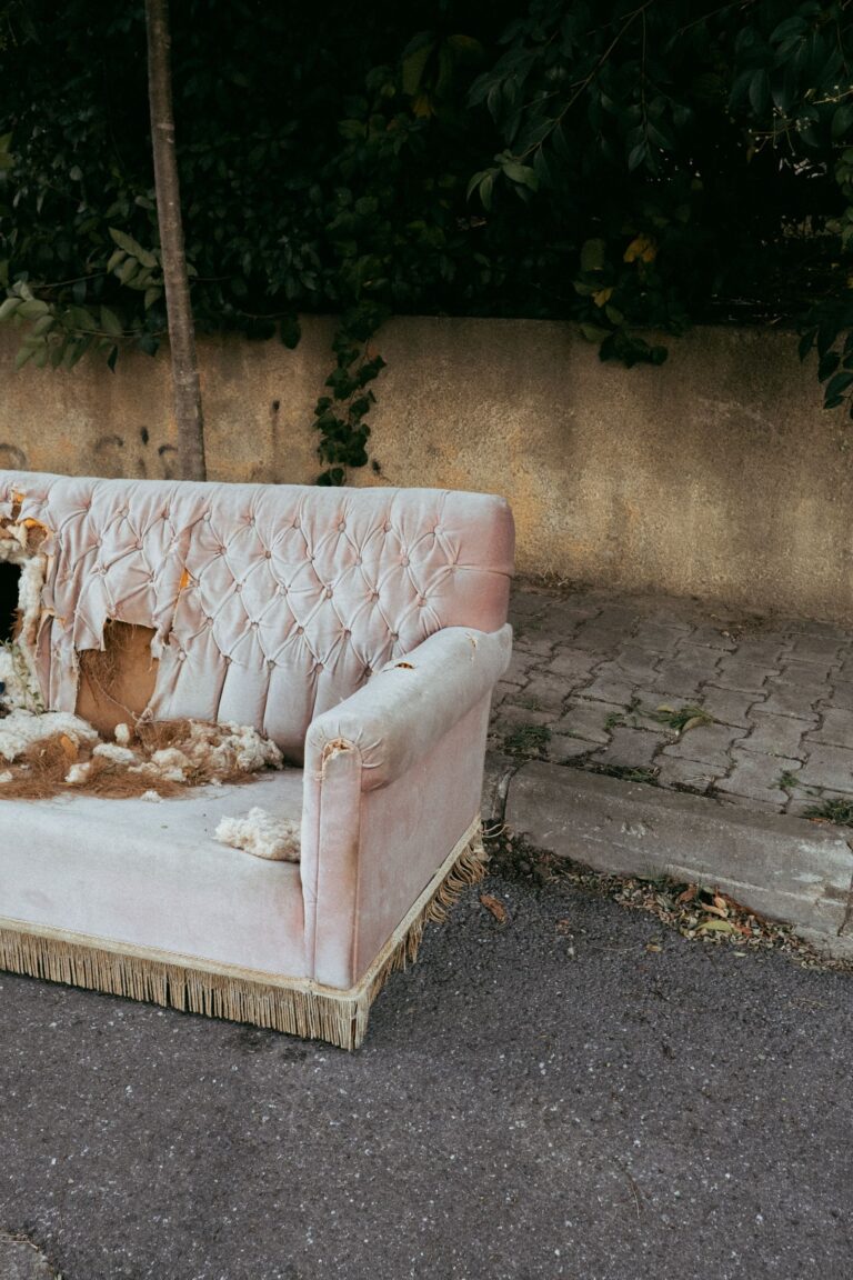 Worn out sofa left on the street instead of being sold