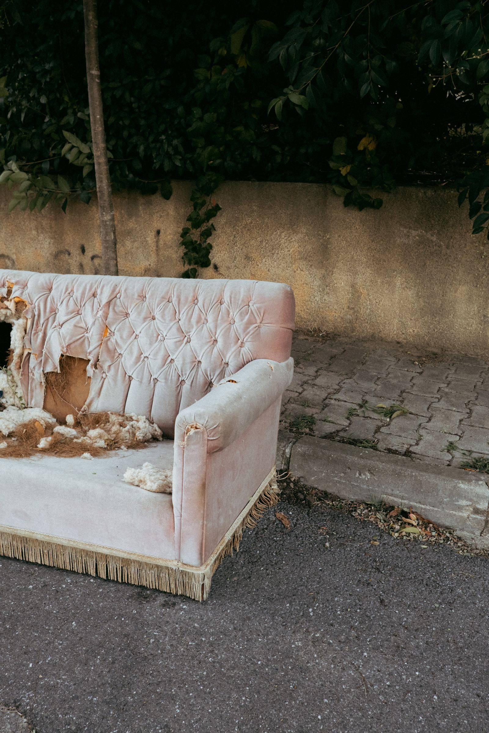 Worn out sofa left on the street instead of being sold