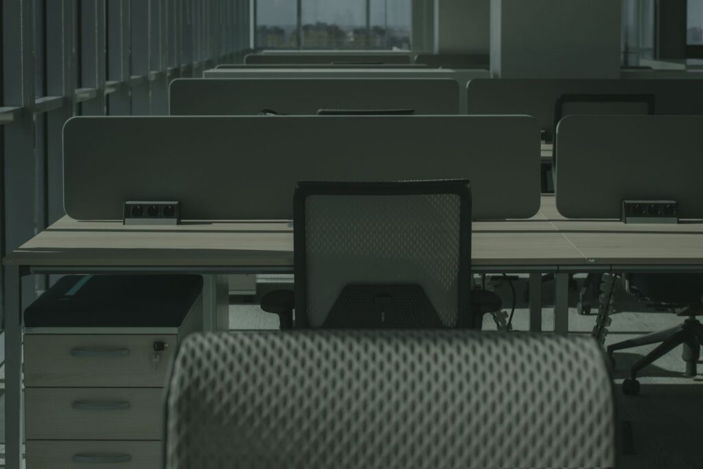 Rows of used office desks and chairs in a Dubai office
